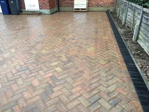 Brindle herringbone driveway laid right up to a timber boundary fence in Guildford